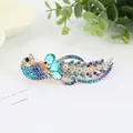 Peacock shape spring hair clip with blue rhinestones and crystals on a golden alloy base - Peacock Blue