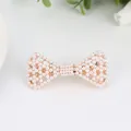 Elegant gold bow hair clip with white pearls and spring clasp for women hair styling - Bow