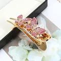 Elegante pinza para el pelo de mariposa dorada con brillantes strass rosas y claros - Mariposa Roja