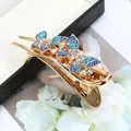 Pinza per capelli a farfalla dorata con strass blu e verdi su espositore - Farfalla Blu