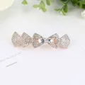 Rose gold hair clip with rhinestone bow design and teardrop stones on a white card - White Bow
