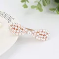 Elegant gold alloy hair clip featuring rows of small pearls with a large center pearl - Round Bowtie