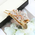 Elegant gold hair clip with sparkling white rhinestones in floral design - Floral White