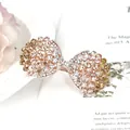 Elegante vlinder haarklem in roségoud met fonkelende kristallen en champagne strassteentjes - Schulprandvorm / Sint-jakobsschelp Champagne