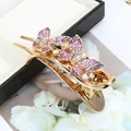 Elegant gold bow hair claw clip featuring pink and white rhinestones in butterfly design - Butterfly Purple
