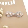 Elegant gold bow hair clip with white pearls and sparkling rhinestones in a Korean style - Round Rhinestone Bowknot