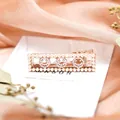 Roségoldene Haarspange mit weißen Perlen und drei glitzernden Strass-Smileys - Smiley
