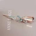 Rose gold bow hair clip with sparkling blue rhinestones and crystal flower design - Ribbon Style / Blue