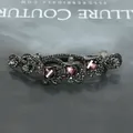 Vintage black metal hair clip featuring grey rhinestones and purple gemstone accents - Purple