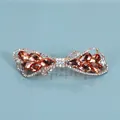 Elegant gold bow hair clip featuring amber faceted gemstones and sparkling rhinestones - Crystal Style / Champagne