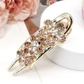 Elegant gold metal hair clip featuring three brown rhinestone flowers with AB crystal centers - Begonia Champagne