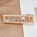 Golden hair clip with white pearls and sparkling rhinestone STAR letter design - STAR