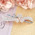 Elegant rose gold spring hair clip with blue and white crystals in a ribbon design - Cymbidium Blue