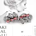 Elegant bow hair clip with pink rhinestones and hollow metal frame for women - Wisteria Red
