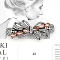 Elegant champagne crystal bow hair clip with sparkling rhinestones on black metal base - Wisteria Champagne