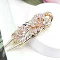Vintage gold flower hair claw with white rhinestones and crystal leaf patterns - Morning Glory White