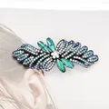 Elegant silver hair clip featuring blue and green rhinestone bow design for ponytails - Camellia Green