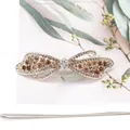 Elegant bow hair clip with sparkling white and champagne rhinestones in metal setting - Ribbon Champagne