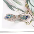 Elegant bow hair clip featuring blue-green rhinestones and sparkling gold finish - Ribbon Blue