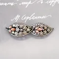 Elegant leaf-shaped hair clip with champagne and iridescent rhinestones on black metal - Twin-Leaf Champagne