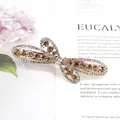 Elegant gold-tone dragonfly hair clip with shimmering champagne and clear rhinestones - Flying Flower Champagne