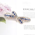 Elegant rose gold butterfly hair clip with blue rhinestones and sparkling crystals - Flying Flower Blue