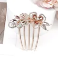 Rose gold floral hair comb with amber crystals on a decorative display stand - Champagne