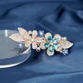 Floral spring hair clip with teal crystals and white rhinestones on a gold base - Double Flower Blue