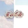 Elegant butterfly hair clip with purple rhinestones and gold alloy base in detail - Bright Red Iris