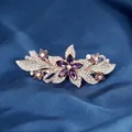 Floral spring hair clip with purple crystal stone on a light gold metal base - Star Flower Purple