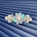 Barrette fleurie dorée avec strass bleus et cristaux sur soie bleue plissée - Bleu