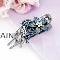 Floral hair claw clip with deep blue and light blue crystals in a refined metal setting - Star Blue