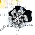 Sparkling rhinestone flower scrunchie in black velvet for elegant hair styling - White