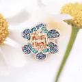 Five-petal flower hair claw in rose gold with blue and cyan crystal rhinestones - Blue