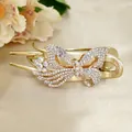 Elegant gold butterfly hair claw with white rhinestones and a delicate crystal flower - White