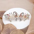 Elegant bow hair clip featuring purple crystals and fine diamonds on a gold base - Butterfly Red