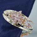 Golden flower hair claw with pink crystals and rhinestones on blue velvet background - Pink