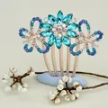 Elegant rose gold hair comb featuring blue rhinestone butterfly and flower motifs - Blue