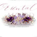 Golden spring hair clip featuring purple rhinestones in a butterfly flower design - Neon
