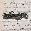 Bow-shaped hair clip in gunmetal grey finish featuring sparkling dark grey rhinestones - Gun Black Black Ribbon
