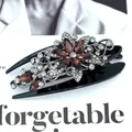 Elegant black hair claw clip featuring a floral design with amber and clear rhinestones - Star Red