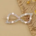 Rose gold hair clip with sparkling rhinestones and white pearls in a bow design - Bow Tie