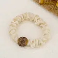 Elegant beige satin scrunchie with a crystal-encrusted sphere for stylish ponytails - Satin / Off White