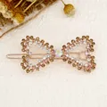 Elegant rose gold bow hair clip featuring amber rhinestones and iridescent center stone - Bowknot Yellow