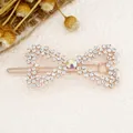 Sparkling rhinestone bow hair clip with rose gold base and iridescent center stone - Bowknot White