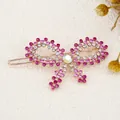 Bow hair clip with pink and clear rhinestones on a golden metal base for women - Red Butterfly
