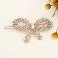 Sparkling rose gold bow hair clip with crystal rhinestones and iridescent center stone - Butterfly White