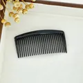 Classic black plastic hair comb for elegant buns and styling on white textured tray - Small Black (8cm)