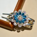 Luxurious gold floral hair claw with sparkling blue rhinestones and crystal accents - Blue