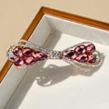 Fermaglio per capelli a fiocco con cristallo rosa e strass su base in metallo oro - Rosso